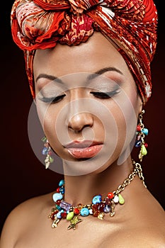 Beautiful mulatto young woman with turban on head