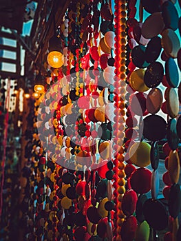 Beautiful multi-colored bead curtains under the lights