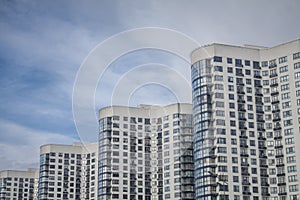 Beautiful multi-storey building of a wave shape diagonally against a blue sky