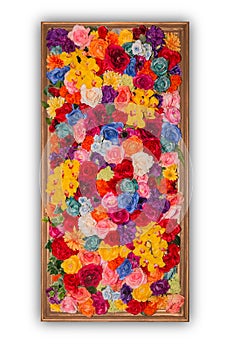 Beautiful multicolored artificial flowers in wooden frame isolated on white