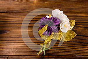 Beautiful multicolored brooch on a wooden table. Top view