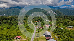 Beautiful Mulu village with road, tropical forest and mountains near Gunung Mulu national park. Borneo. Sarawak.