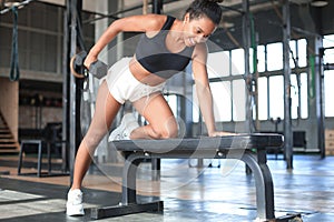 Beautiful muscular fit woman exercising building muscles