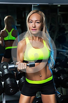 Beautiful muscular fit woman exercising building muscles
