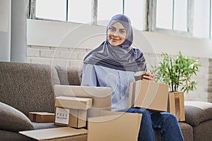 Beautiful Muslim business woman working from home and getting orders ready