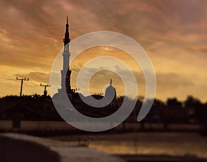 Beautiful Muslim Mosque on river side under evening light sky