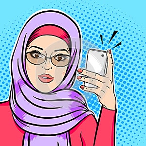Beautiful muslim woman in hijab holding mobile phone reading sms or taking selfie concept vector in pop art comic retro style