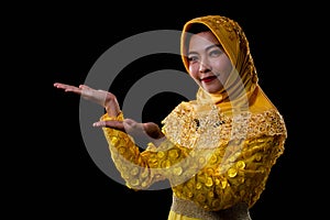 A beautiful muslim woman making her gestures for showing something with copy space