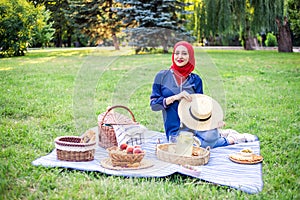 Beautiful Muslim woman on picnic at sunny day.