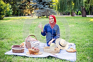 Beautiful Muslim woman on picnic at sunny day.