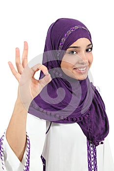 Beautiful muslim woman wearing a hijab gesturing ok photo