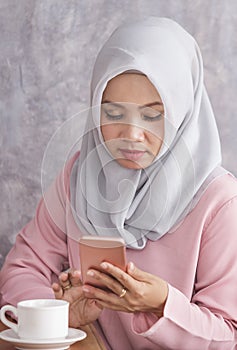 Beautiful muslim women busy on her mobilephone