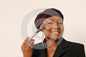 Beautiful muslim young woman retouching make-up on her face. Mock-up.