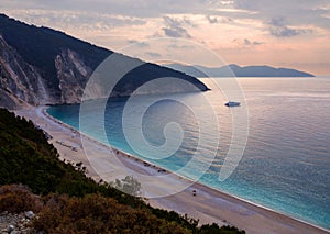 Beautiful Myrtos beach with turquoise water on the Sunset on the island of Kefalonia in the Ionian Sea in Greece