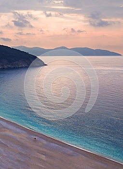 Beautiful Myrtos beach with turquoise water on the Sunset on the island of Kefalonia in the Ionian Sea in Greece