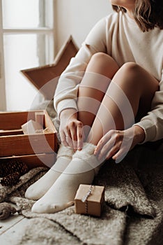naked female legs in white socks girl sitting on the bed