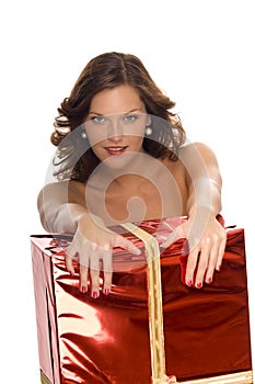 Beautiful naked woman behind a big Christmas gift