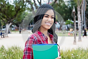 Beautiful native latin american female student outdoors on campus