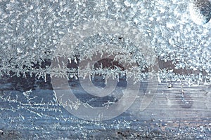 Beautiful natural background or texture of frozen transparent glass on the window in winter, strong cold concept, horizontal image