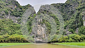 Beautiful Natural Landscape On Ngo Dong River With Limestone Mountain And Cave In Tam Coc Of Ninh Binh Province, Vietnam.