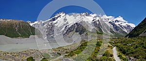 Beautiful natural landscape. Rocks, lake and snowy mountains in the background.