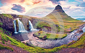 Beautiful natural magical scenery with a waterfall Kirkjufell near the volcano at dawn  in Iceland. Exotic countries. Amazing