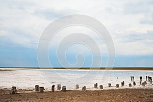 Beautiful natural textural background on a salt lake, river. Salt lake Elton, Russia, before rain and thunder, sunset on the water