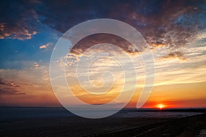 Beautiful natural textural background of the sunset on the lake, river. Salt lake Elton, sunset on the water