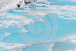 Beautiful natural travertine pools and terraces view from Pamukkale, Denizli, Turkey. Cotton castle at sunny bright day