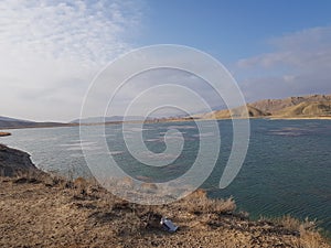 Beautiful natural view of blue lake and mountains with blue sky and white clouds