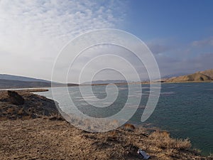 Beautiful natural view of blue lake and mountains with blue sky and white clouds