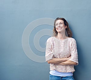 Beautiful natural woman smiling with arms crossed