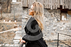 Beautiful natural young smiling blonde woman wearing knitted woollen sweater.