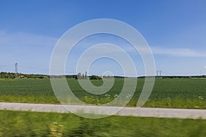 Beautiful nature countryside landscape view. Green fields on blue sky with white clouds background. Europe