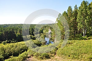 Beautiful nature green trees and a river in the distance. Olenyi Ruchy is a natural park in the Sverdlovsk Region on the territory