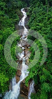 beautiful nature landscape krating waterfall and small photographer in the rainy season and refreshing greenery forest in the