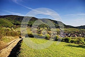 Beautiful nature landscape panorama.Green Meadow with blue sky and Village In Summer, Slovakia. Traveling, agriculture and hiking.