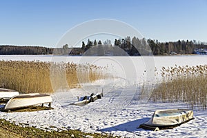 Beautiful nature and landscape photo of lake with ice and boats in Sweden Scandinavia