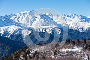 Beautiful nature lanscape with Caucasus mountain and pine forest covered with snow in winter. Cable car at Hatsvali ski resort