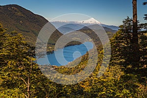 The beautiful nature of Patagonia forests the volcano of the river and lake through the sunset