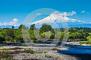 The beautiful nature of Patagonia forests the volcano of the river and lake through the sunset