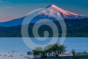 The beautiful nature of Patagonia forests the volcano of the river and lake through the sunset