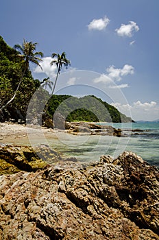 Beautiful nature, tropical beach with clear water and stones. reflection and cloudy blue sky