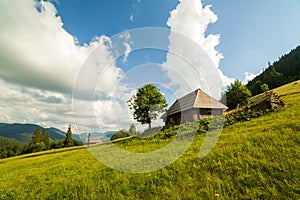 Beautiful nature and a wonderful landscape around a wooden hut, in a clearing located on the slopes of the Carpathian