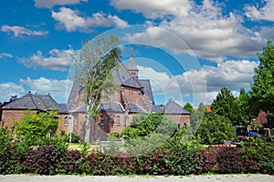 Beautiful neo gothic medieval St. Rochus church, green garden trees,  now in use as Limburg archery museum - Steyl, Netherlands