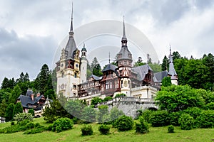 Beautiful neo-Renaissance building of Peles Castle Castelul Peles near Bucegi Mountains Muntii Bucegi in a cloudy summer day