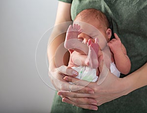 Beautiful new born baby resting on mom`s hands