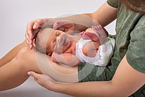 Beautiful new born baby resting on mom`s hands