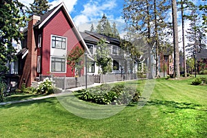 Beautiful new contempory suburban attached townhomes with colorful summer gardens in a Canadian neighborhood.