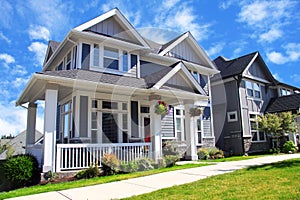 Beautiful new contempory suburban houses with colorful summer ga